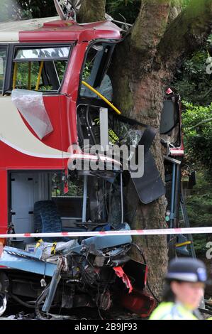 An iconic red double decker London bus crashed into a tree in Croydon, London Stock Photo