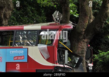 An iconic red double decker London bus crashed into a tree in Croydon, London Stock Photo