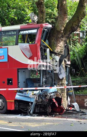 An iconic red double decker London bus crashed into a tree in Croydon, London Stock Photo