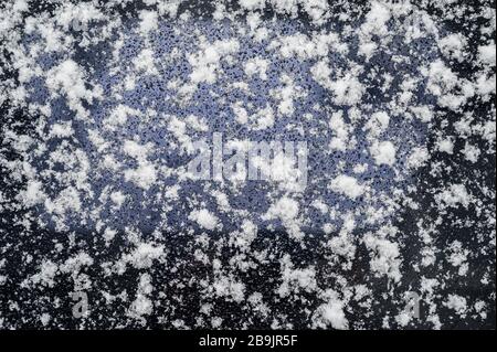 Snow on glass surface. Natural texture background. Stock Photo