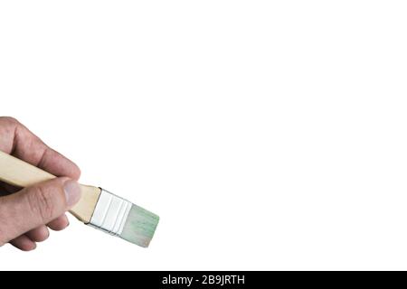 Hand holding paint brush on spiral notebook. Stock Photo