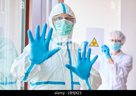 Doctors in protective clothing enforce ban on visits to clinic because of Covid-19 epidemic Stock Photo