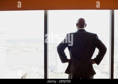 Man looking through window Stock Photo
