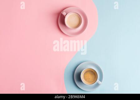 Decorative composition from two ceramic cups of freshly brewed aromatic coffee drink on a pastel blue pink background as a symbol of yin and yang. Fla Stock Photo