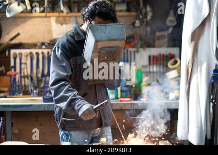 young welder technician working in workshop Stock Photo