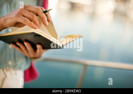 Woman flicks through a diary. Stock Photo