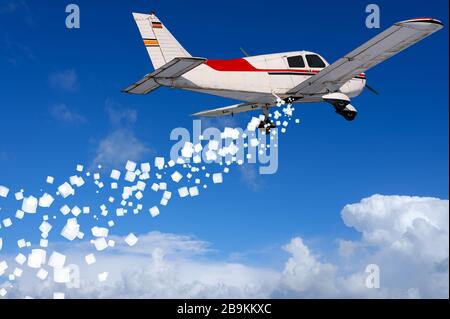 Small airplane distributes toilet paper from the air Stock Photo