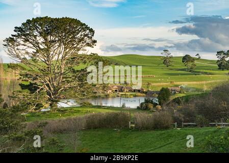 View overlooking the Party Tree and The Green Dragon pub at the Hobbiton Movie Set, New Zealand