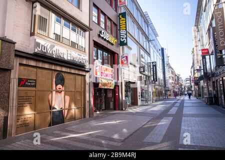 Coronavirus / Covid 19 outbreak, March 24th. 2020. Only few people on shopping street Hohe Strasse, usually visited by thousands of people, Cologne, G Stock Photo