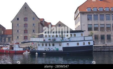 COPENHAGEN, DENMARK - JUL 05th, 2015: Colourful facades and restaurants on Nyhavn embankment and old ships along the Nyhavn Canal Stock Photo