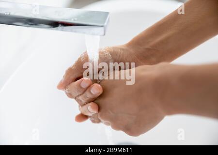 Female wash hands under flowing water close up view Stock Photo