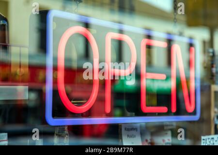 Red neon Open sign in a shop window, UK Stock Photo