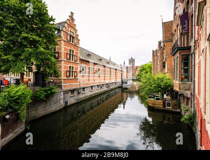 One of Ghent's canals located in dowtown with typical buildings in a cloudy day. Stock Photo