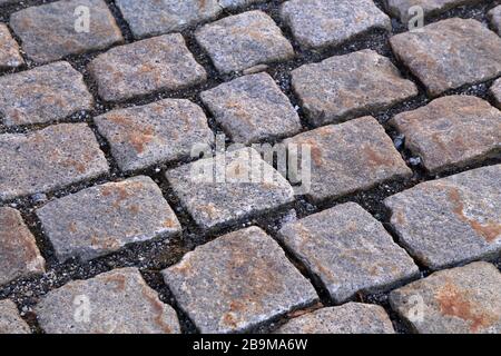 Abstract background of old cobblestone pavement close-up. Stock Photo