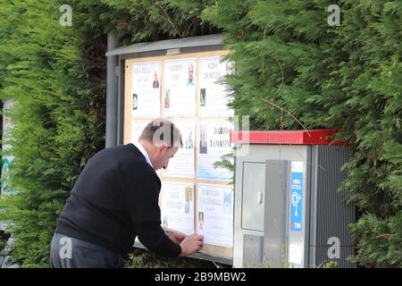 Pergine Valsugana, Italy. 24th Mar 2020. Most part of Europe is today on a sweeping confinement to try to slow down the spread of the Covid-19 Pandemic. A men updating the obituaries board. (Photo by Pierre Teyssot/ESPA-Images) Credit: European Sports Photographic Agency/Alamy Live News Stock Photo
