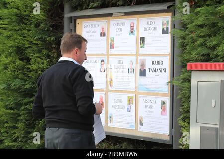 Pergine Valsugana, Italy. 24th Mar 2020. Most part of Europe is today on a sweeping confinement to try to slow down the spread of the Covid-19 Pandemic. A men updating the obituaries board. (Photo by Pierre Teyssot/ESPA-Images) Credit: European Sports Photographic Agency/Alamy Live News Stock Photo