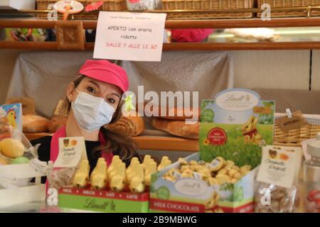 Pergine Valsugana, Italy. 24th Mar 2020. Most part of Europe is today on a sweeping confinement to try to slow down the spread of the Covid-19 Pandemic. At the baker shop where the personal works with a mask before Easter. (Photo by Pierre Teyssot/ESPA-Images) Credit: European Sports Photographic Agency/Alamy Live News Stock Photo