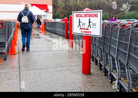 Sterling, USA - March 23, 2020: People customer by shopping carts at entrance to Costco discount membership club store during Coronavirus Covid-19 out Stock Photo