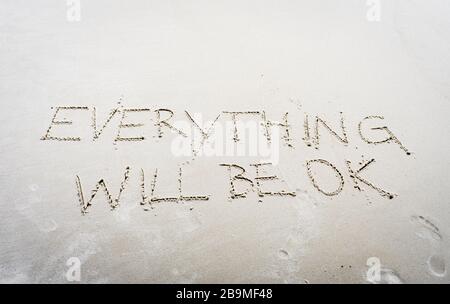 everything will be ok written on sand Stock Photo