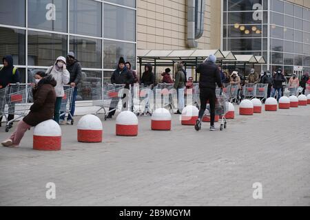 Bucharest, Romania - March 24, 2020: Shoppers stand in a queue outside a supermarket, after a Coronavirus lockdown is announced. Stock Photo