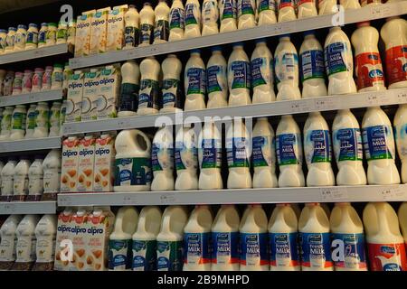 Dubai UAE December 2019 Milk bottles arranged on shelves for sale. Variety of sizes. Also present flavored milk strawberry milk, camel milk, coconut m Stock Photo