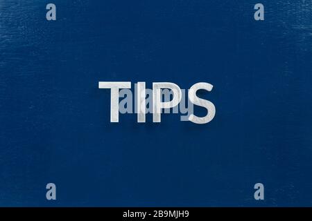 the word tips laid with silver letters on blue color surface Stock Photo