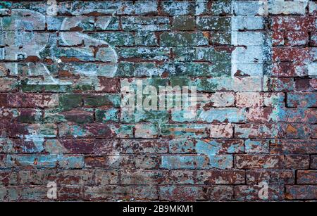 old faded and distressed exterior brick wall background Stock Photo