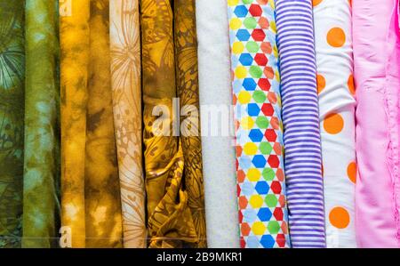 Rolls of various fabric styles  in a drapery store Stock Photo