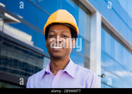 Portrait of professional architect in protective yellow helmet. Engineer and architect concept. Stock Photo