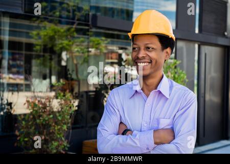 Portrait of professional architect in protective yellow helmet. Engineer and architect concept. Stock Photo