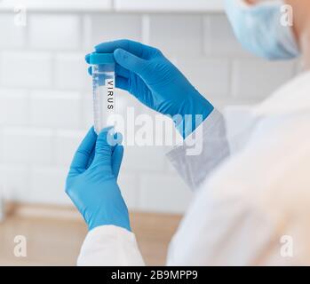 Female Scientist Medical Research Lab researching test tubes virus covid -19 coronavirus in laboratory Stock Photo