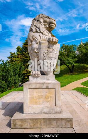 Lublin, Lubelskie / Poland - 2019/08/18: Monumental statue of a lion, symbol of Lviv city in front of medieval Lublin Castle royal fortress in histori Stock Photo