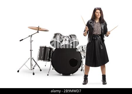 Full length portrait of a young woman drummer with drumsticks with a drum set isolated on white background Stock Photo