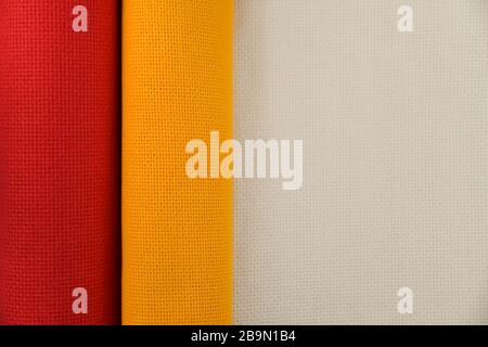 Red and yellow folded canvas for embroidery with copy spase Stock Photo