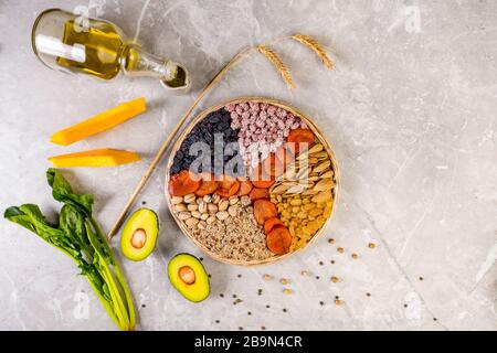 Food sources of vitamin E, high in antioxidants, anthocyanins, minerals and fiber, The concept of healthy food for brain and heart on concrete backgro Stock Photo