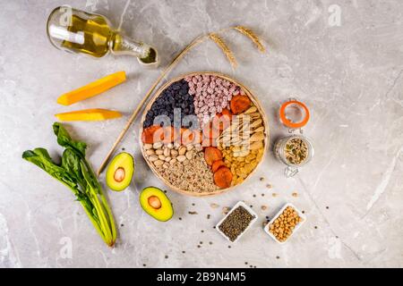 Food sources of vitamin E, high in antioxidants, anthocyanins, minerals and fiber, The concept of healthy food for brain and heart on concrete backgro Stock Photo