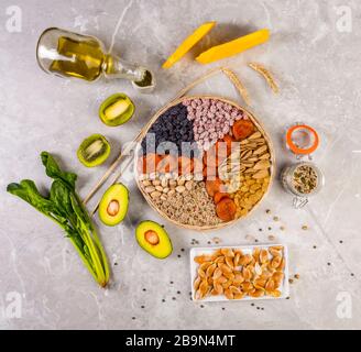 Food sources of vitamin E, high in antioxidants, anthocyanins, minerals and fiber, The concept of healthy food for brain and heart on concrete backgro Stock Photo