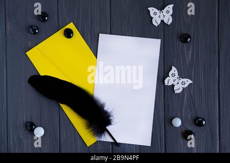 Mock up with a letter envelope, black pen on a gray wooden background. Frame for template text on email newsletter, photo for blog, site. Stock Photo