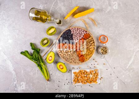 Food sources of vitamin E, high in antioxidants, anthocyanins, minerals and fiber, The concept of healthy food for brain and heart on concrete backgro Stock Photo