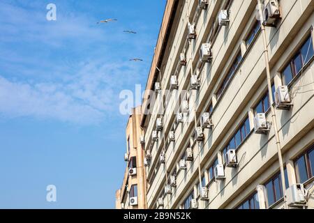 Old facade of a building with lot of air condition units Stock Photo