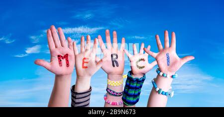 Children Hands Building Word Merci Means Thank You, Blue Sky Stock Photo