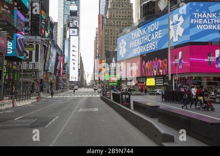 Times Square is virtually empty of tourists and New Yorkers due to the Coronavirus and the state lockdown in New York. Stock Photo