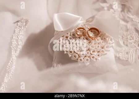 gold wedding rings on a lace pad. Romantic theme for newlyweds. wedding accessories Stock Photo