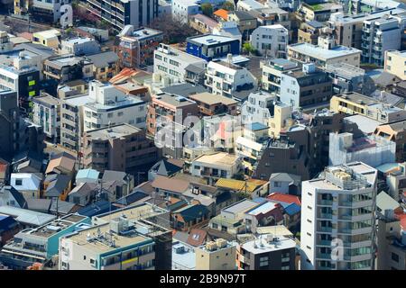 Aerial view of densely populated residential area with multiple apartment buildings in Tokyo, Japan. Crowding of residential constructions in Asia. Stock Photo