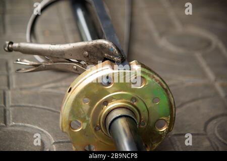 Man Man tightens the nut with a wrench, assembling detail of the system rolling gate. Stock Photo