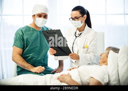healthcare in hospital concept. two doctors making medical examination of old lady Stock Photo