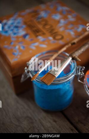 paint brush and blue painted floral cigar box Stock Photo