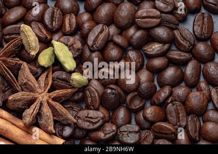 The composition of coffee and cane sugar on a stone background with the addition of anise and cinnamon. Stock Photo