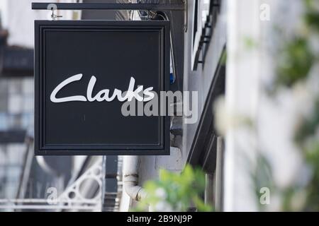 A sign sits above a Clarks shoe shop in Guildford, Surrey U.K.Friday, March 20, 2020