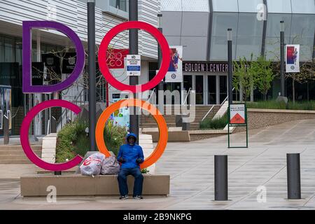 Sacramento, CA, USA. 24th Mar, 2020. A lone person sits near the entry to DOCO that is empty of people during the coronavirus outbreak on Tuesday, March 24, 2020 in Sacramento. Credit: Paul Kitagaki Jr./ZUMA Wire/Alamy Live News Stock Photo